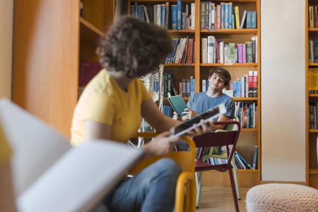 teenagers-looking-each-other-library_23-2147860570